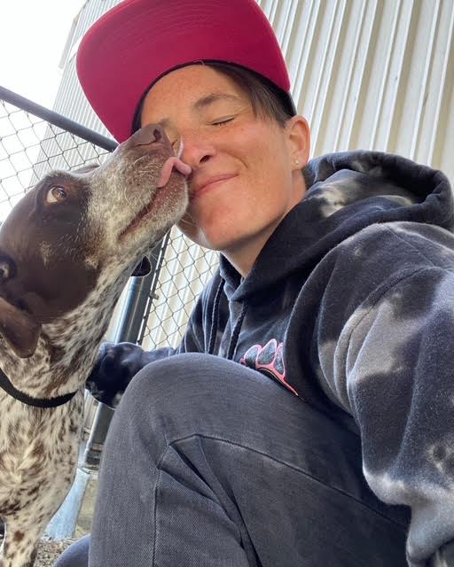 Katie sharing a moment with a dog